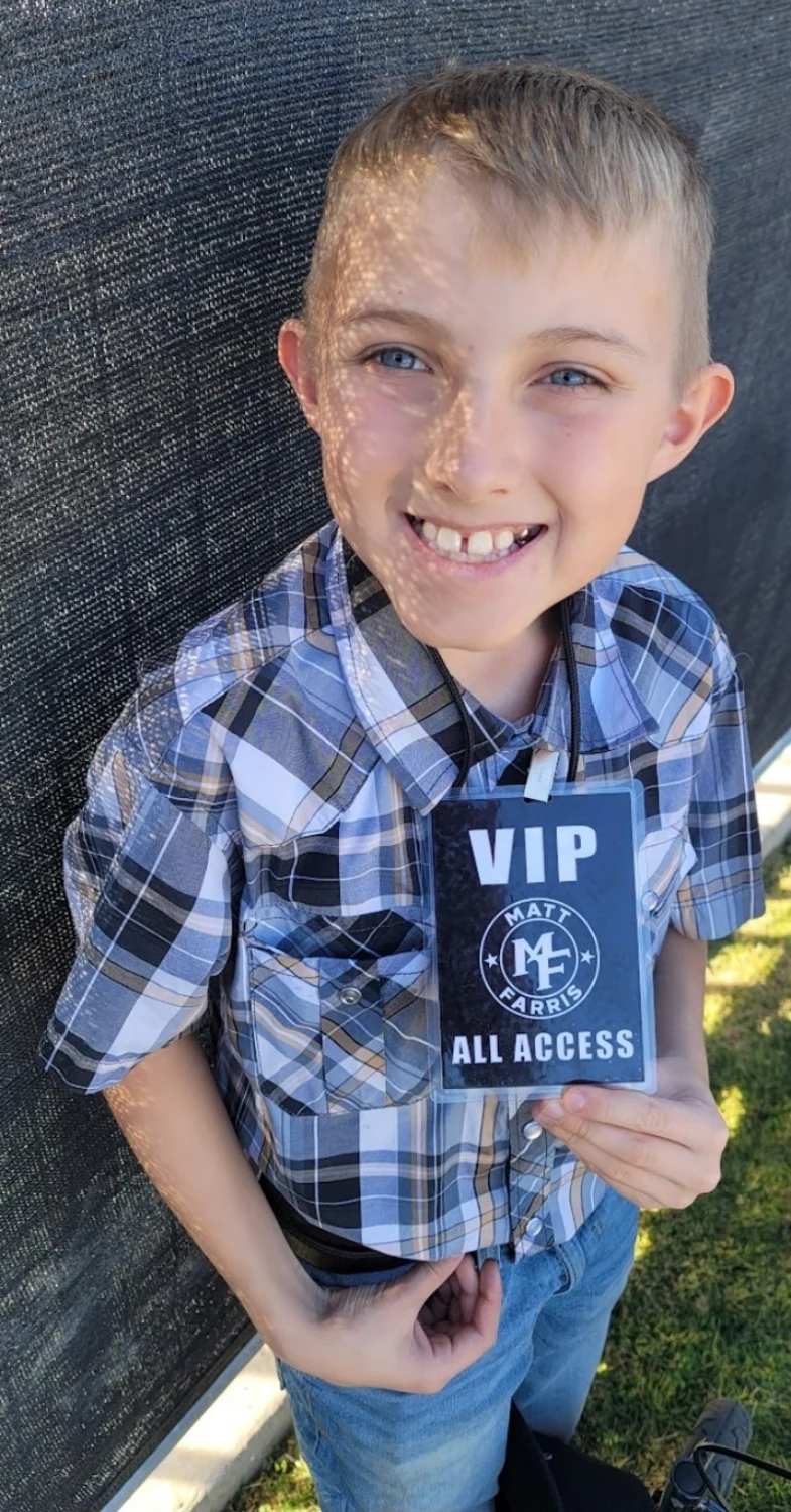 Austin smiling with his event pass